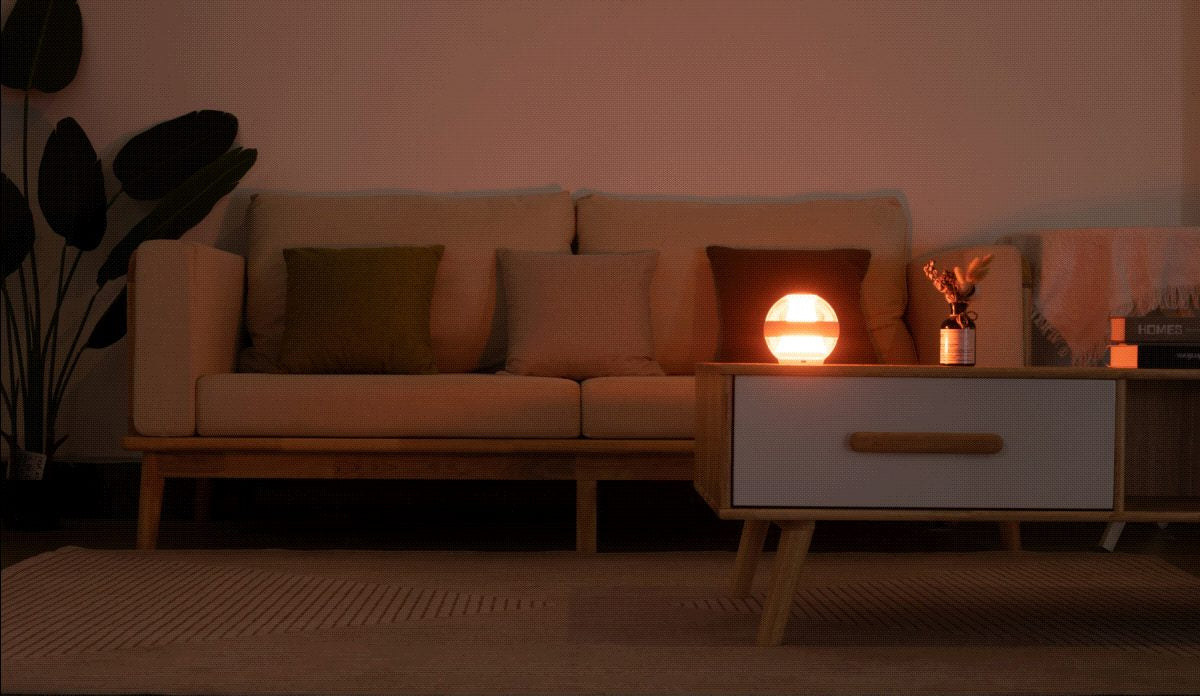 The Serenity Light breathing softly beside a sofa in a dim evening room