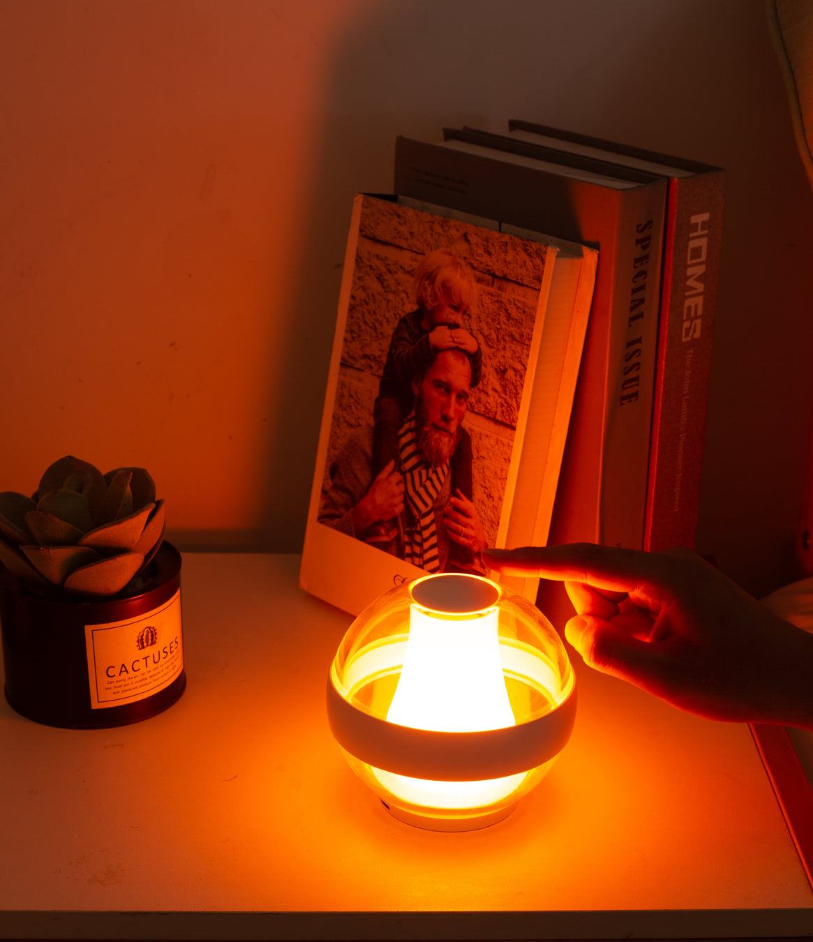 Hand touching the Serenity Light in Flame Warm mode