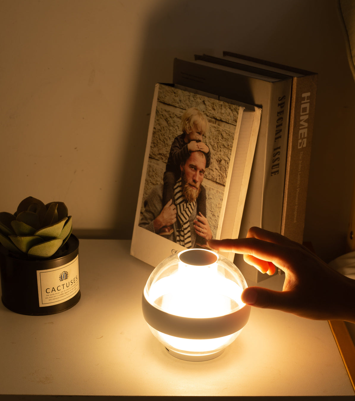 Hand touching the Serenity Light in Moon White mode